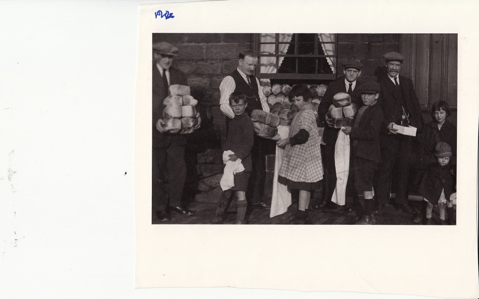 0000685_HalfmoonCamerawork_ToBuildJerusalem_Image_MenHandingOutBreadtoChildren.jpg